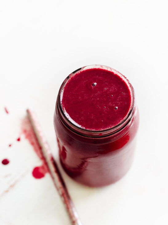 frozen berry smoothie in a jar with straw