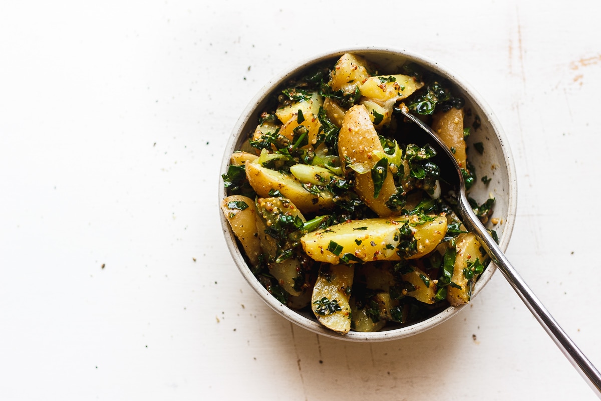 kale potato salad with mustard dressing in a bowl