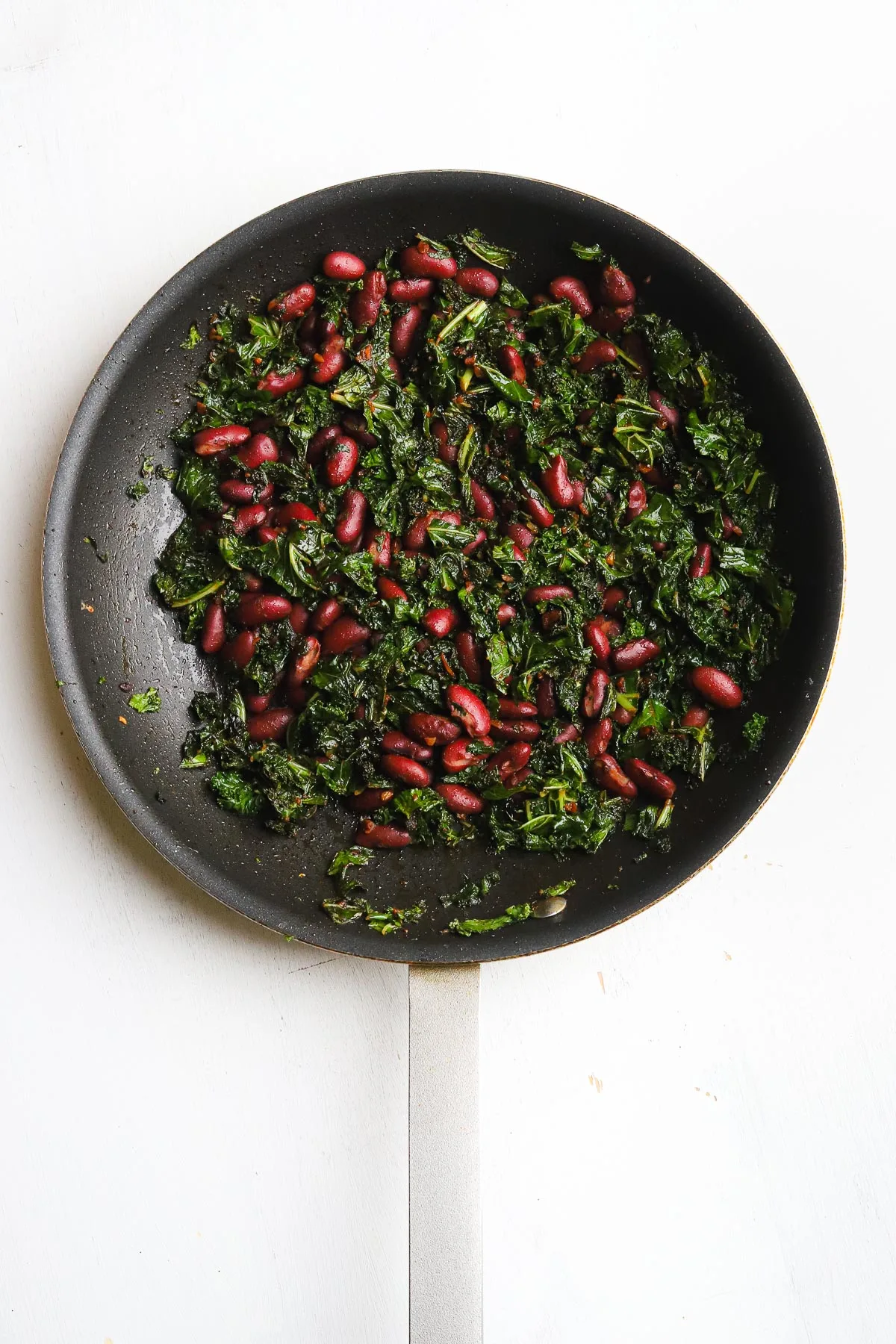 kidney beans and kale in a skillet