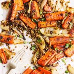 maple roasted carrots with lentils and onions on a sheet pan