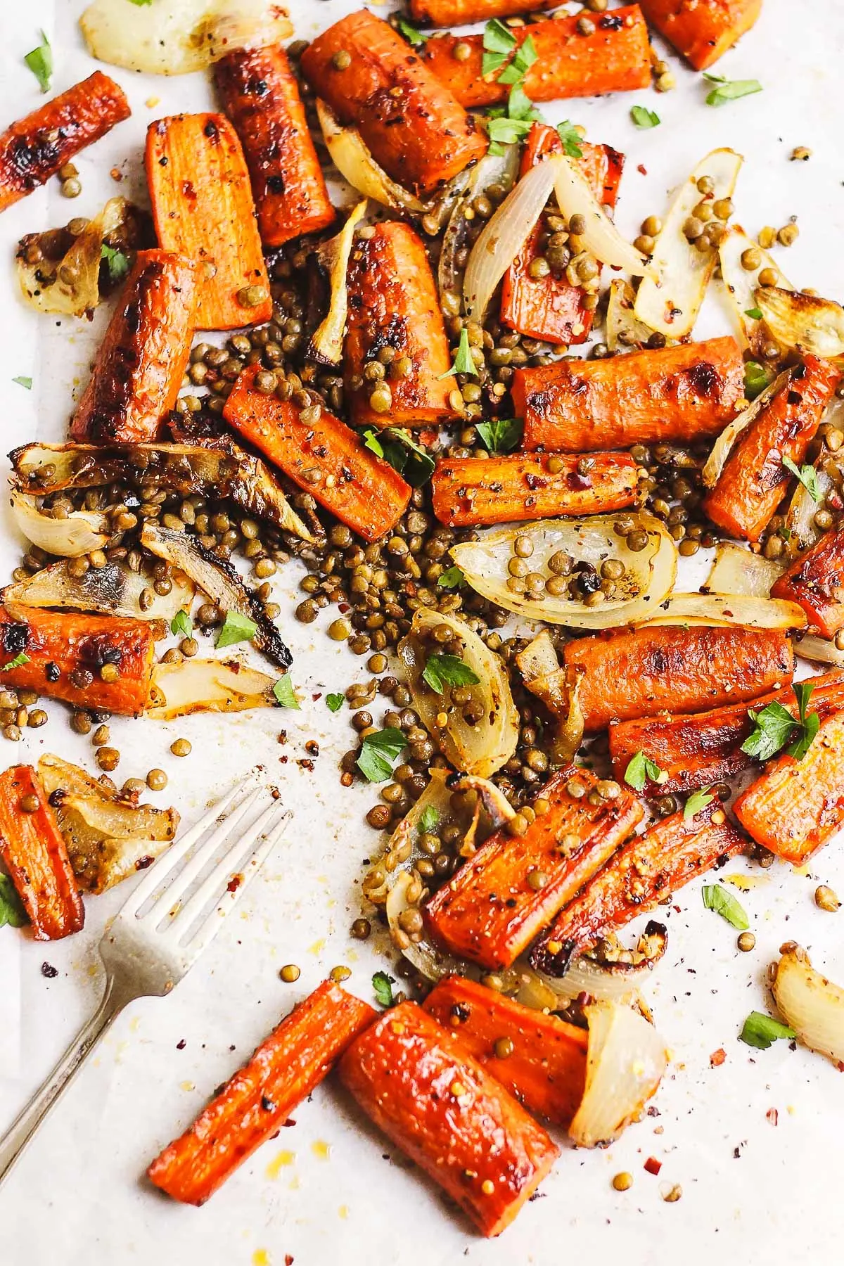 maple roasted carrots with lentils and onions on a sheet pan