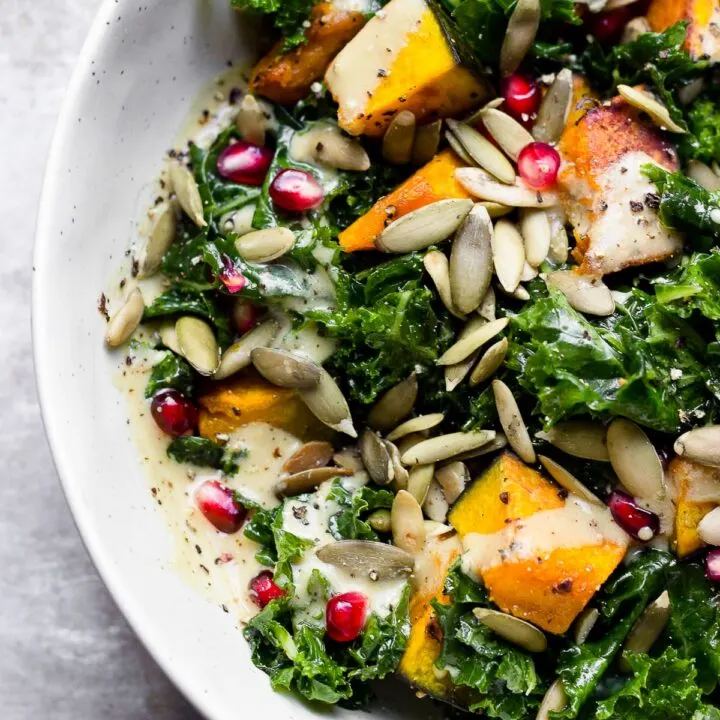 bowl with kale squash pomegranate and pumpkin seed