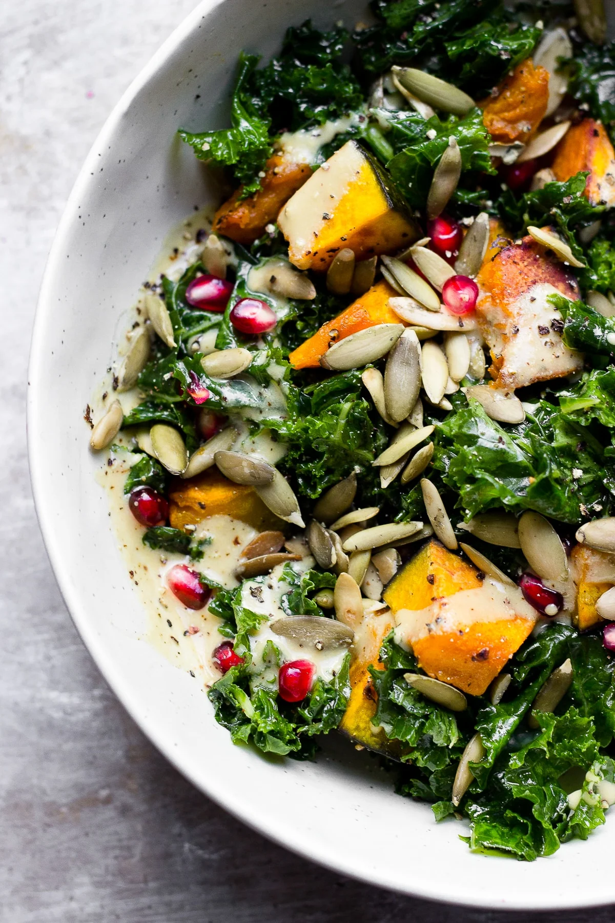 bowl with kale squash pomegranate and pumpkin seed