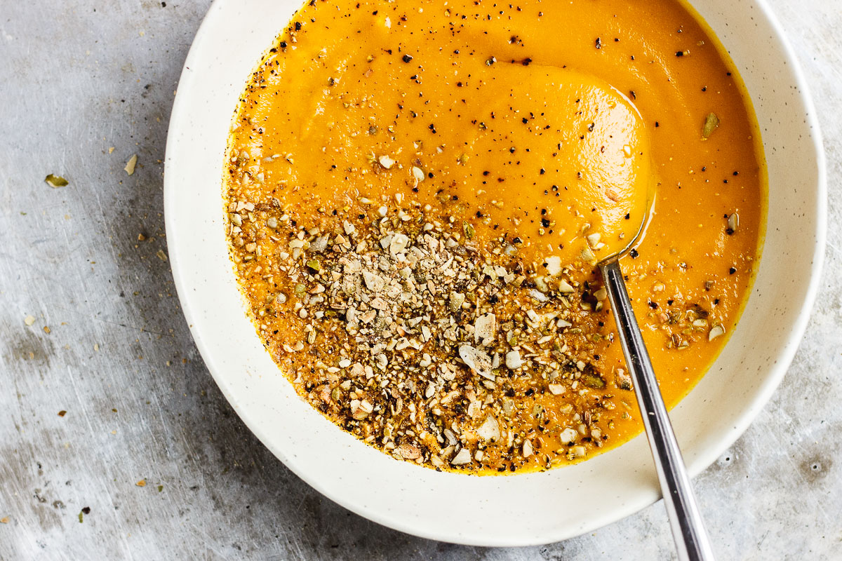 pumpkin soup in a bowl with spoon