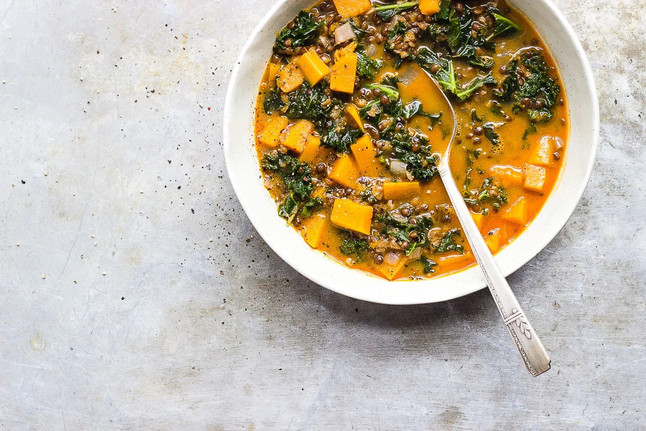 Red Curry Lentil Stew with Butternut Squash + Kale | Red curry lentil stew with butternut squash, kale and creamy coconut milk. It's naturally gluten-free and vegan. It's a hearty fall lentil stew. #butternutsquashrecipes #fallstew #lentilstew