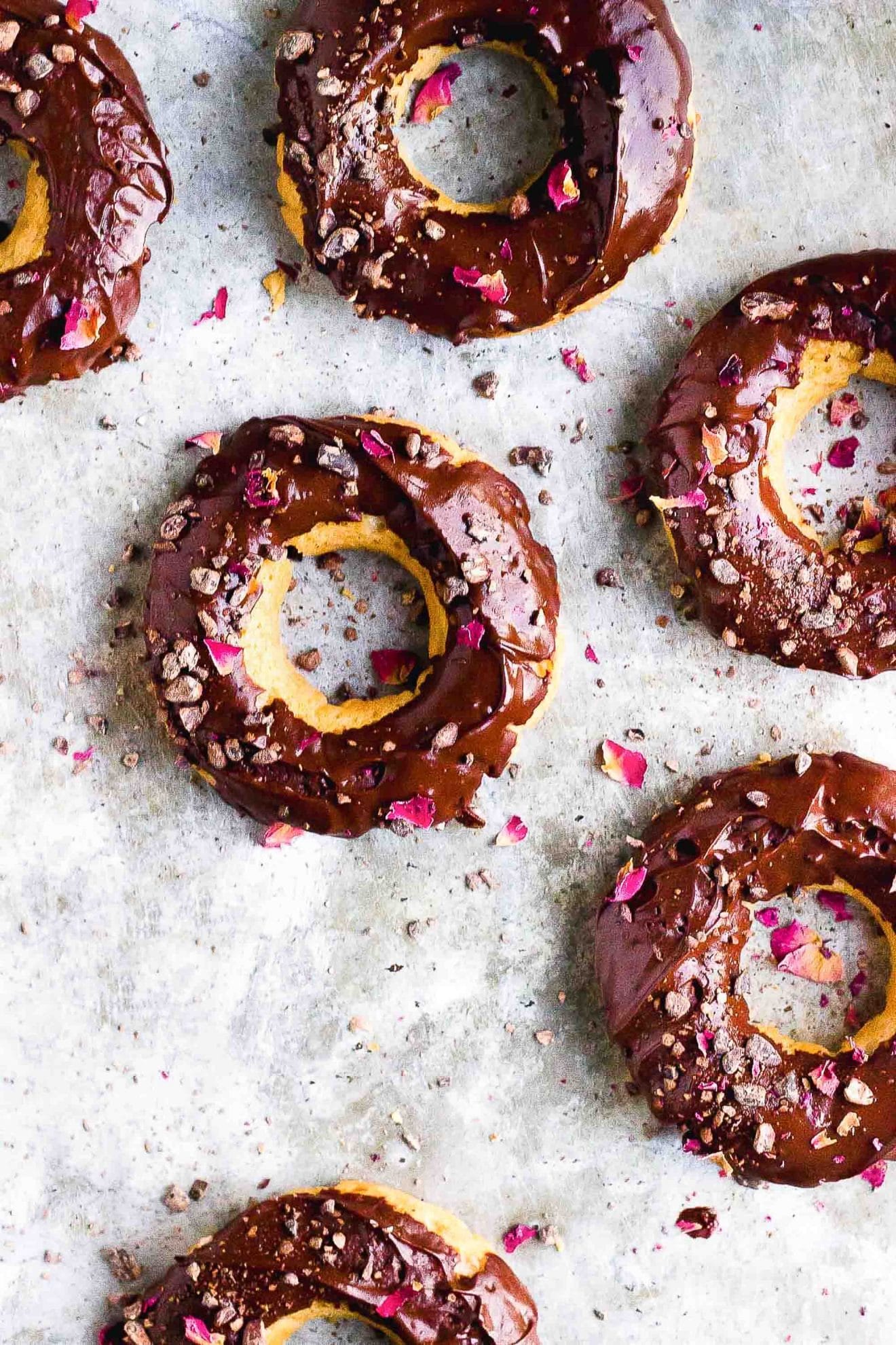 vanilla donuts with chocolate frosting and rose petals