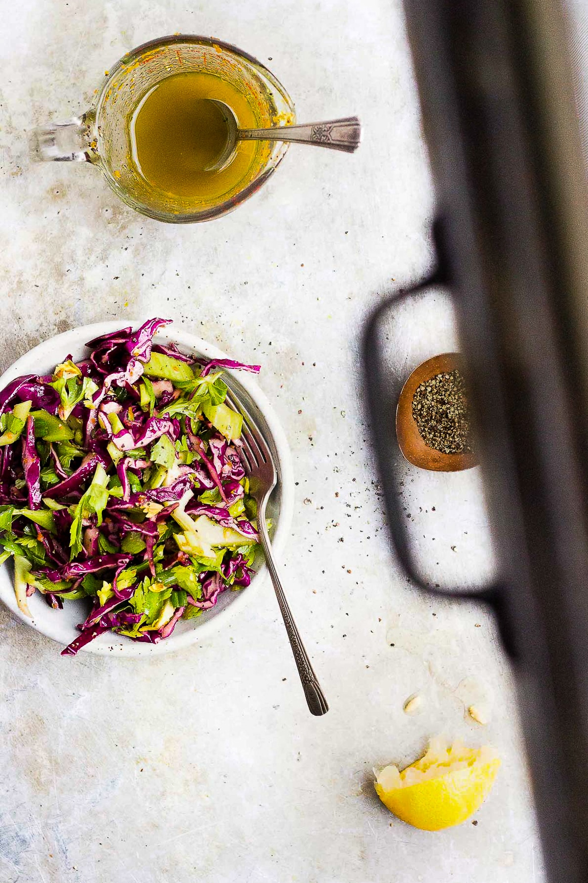 red cabbage celery salad in a bowl with turmeric dressing