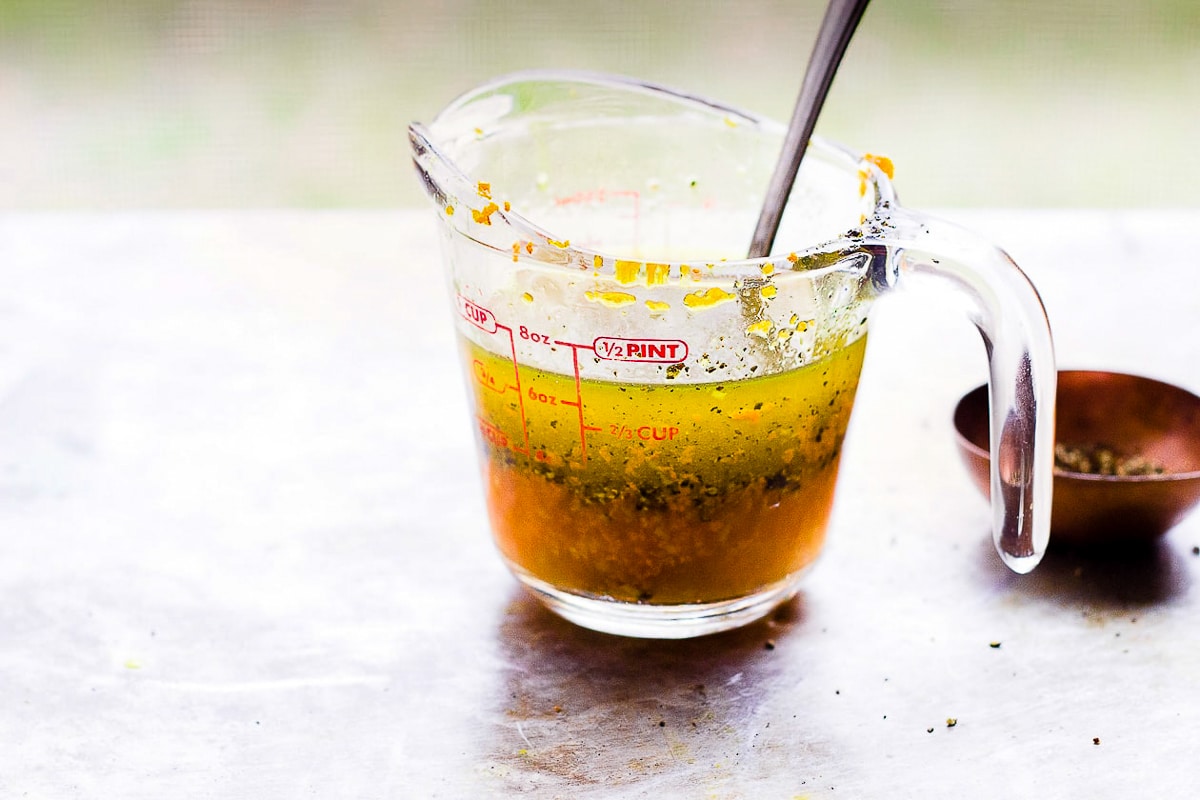 turmeric and black pepper vinaigrette in a glass measuring cup