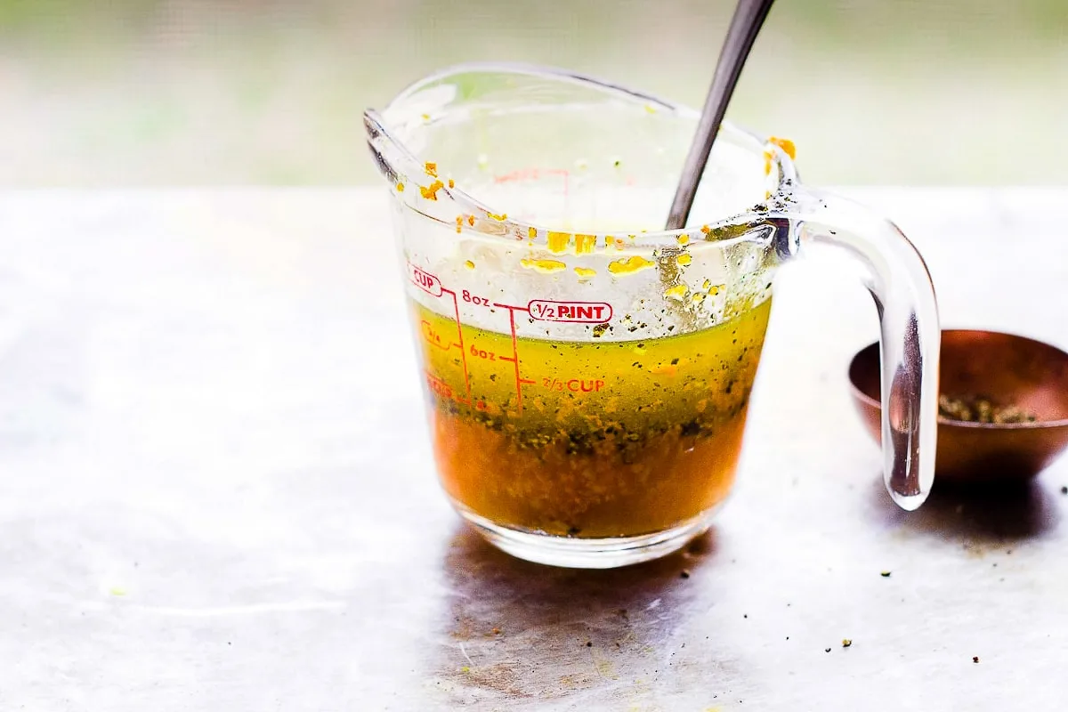 turmeric and black pepper vinaigrette in a glass measuring cup