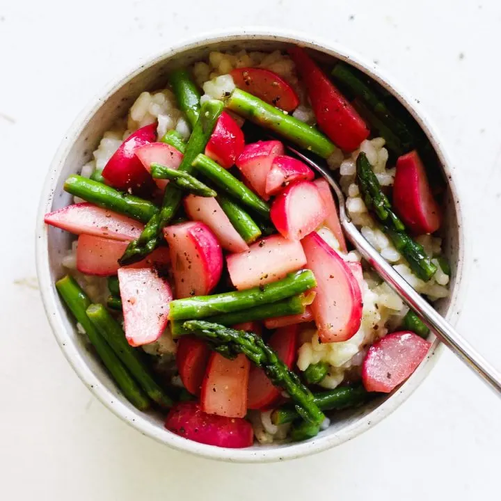 vegan risotto with spring vegetables in a bowl