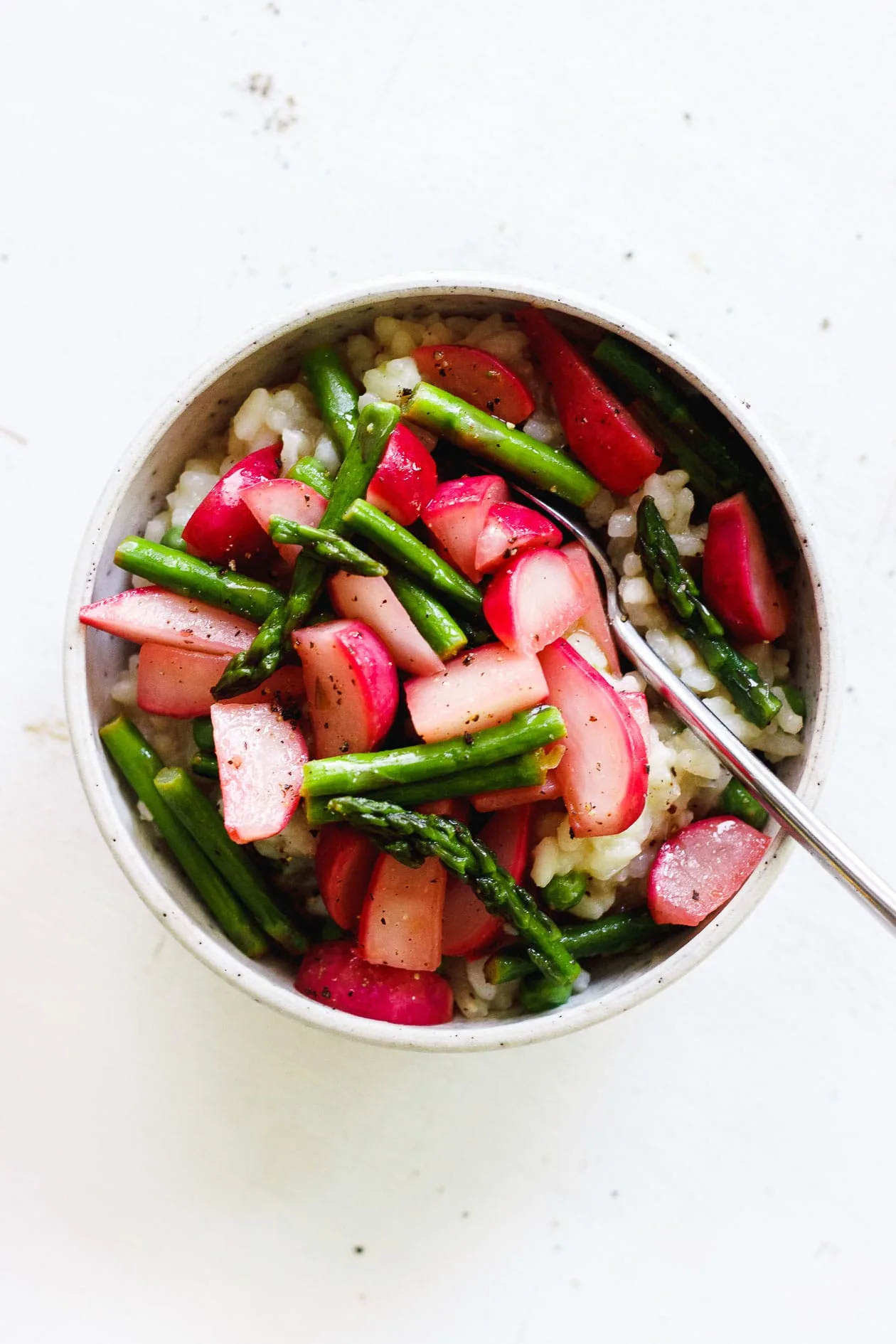 vegan risotto with spring vegetables in a bowl