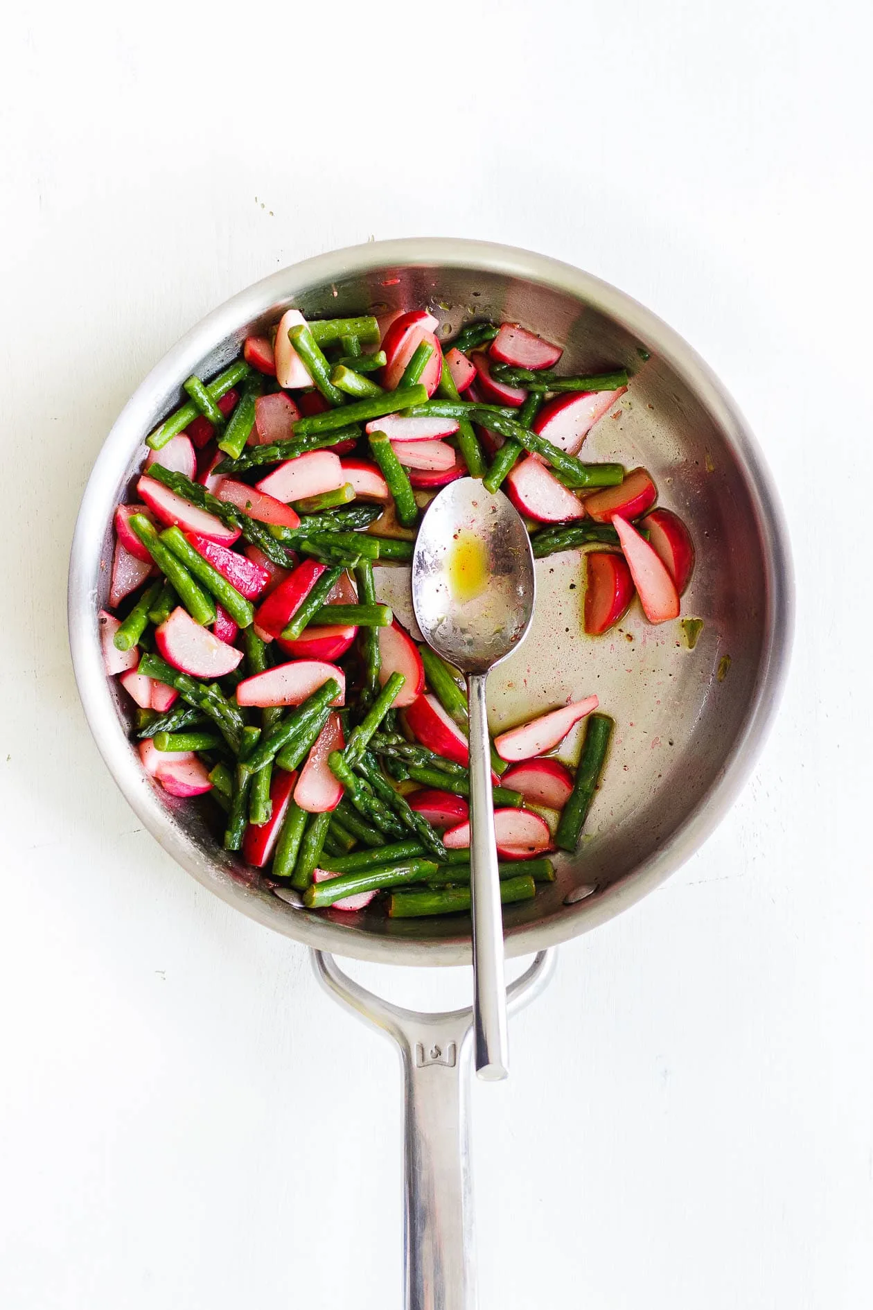 asparagus and radishes in a saute pan