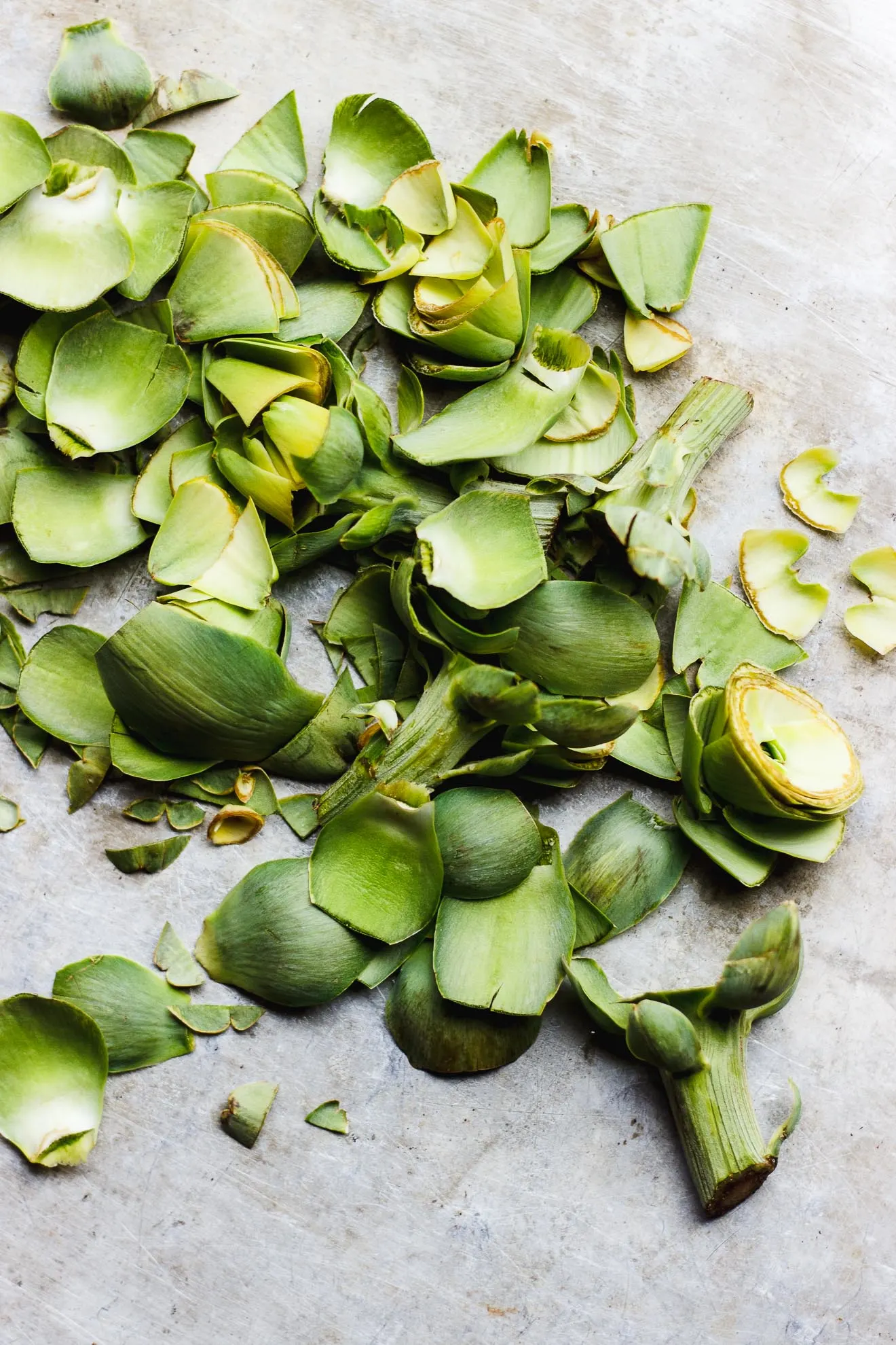 Easy Braised Artichokes with Lemon + Macadamia Nut Oil | Super easy stovetop braised artichokes summed in vegetable broth and dressed with fresh lemon juice and macadamia nut oil. Artichokes as an entree made easy. #artichokes #braisedartichokes