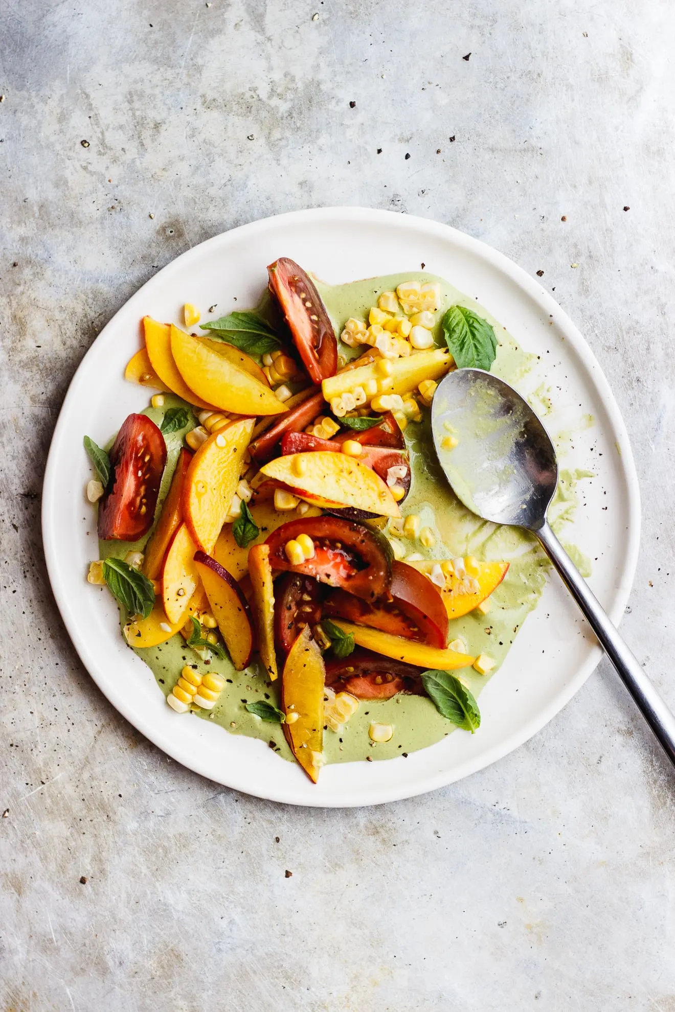 basil sauce and tomato peach salad