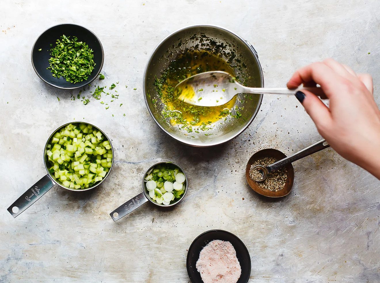 diced cucumber and herbs in bowls