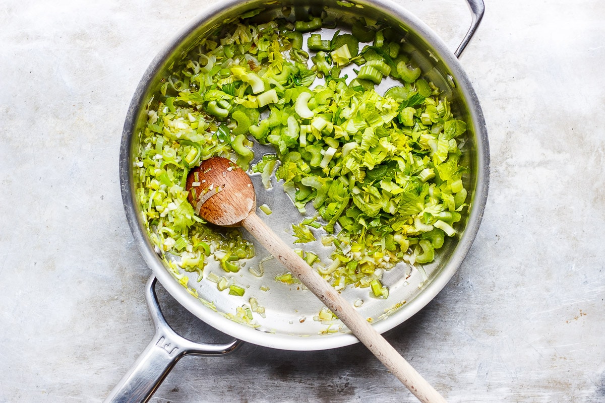 diced celery sautéing in a pan