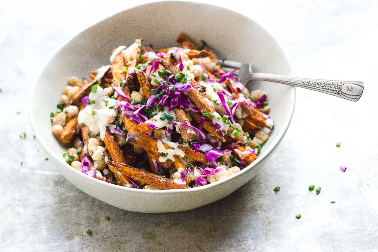 Loaded Sweet Potato Fries with Crispy Beans + Garlic Tahini Cream | Loaded sweet potato fries with crispy white beans and creamy garlic tahini cream. Naturally gluten-free, vegan comfort food.&nbsp;