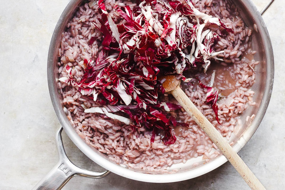 red wine radicchio risotto in pan with spoon 