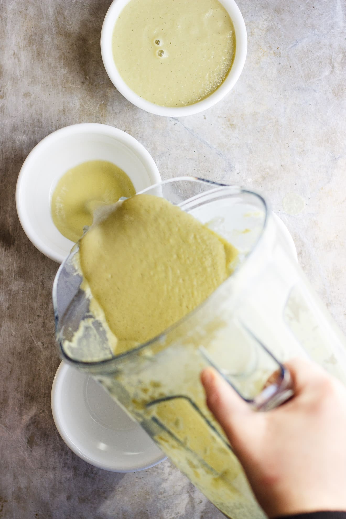 vegan cream of celery soup poured from a blender
