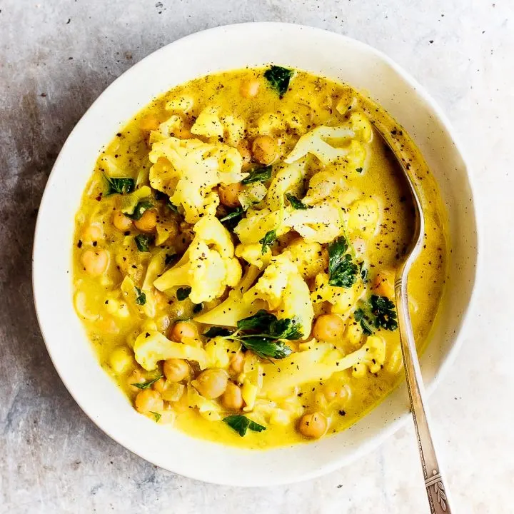 cauliflower stew in a bowl with a spoon