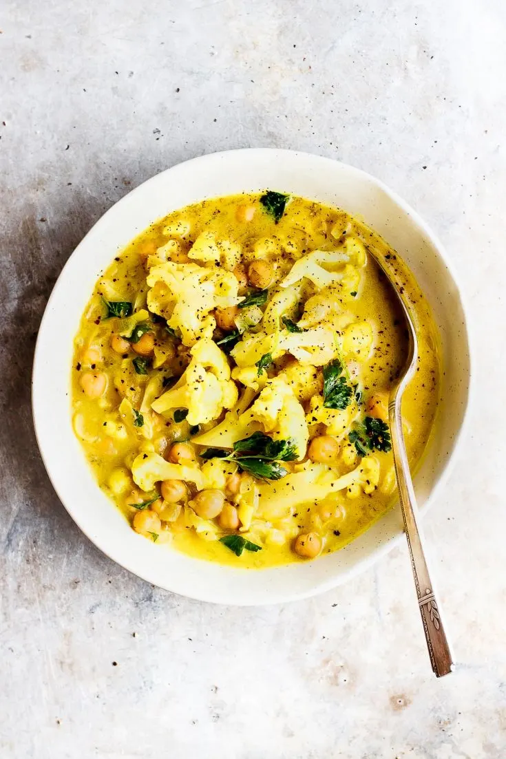 cauliflower stew in a bowl with a spoon