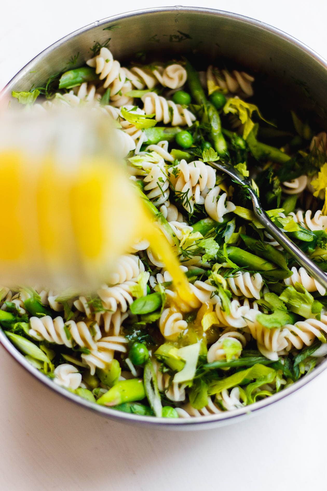 pasta salad with dressing poured