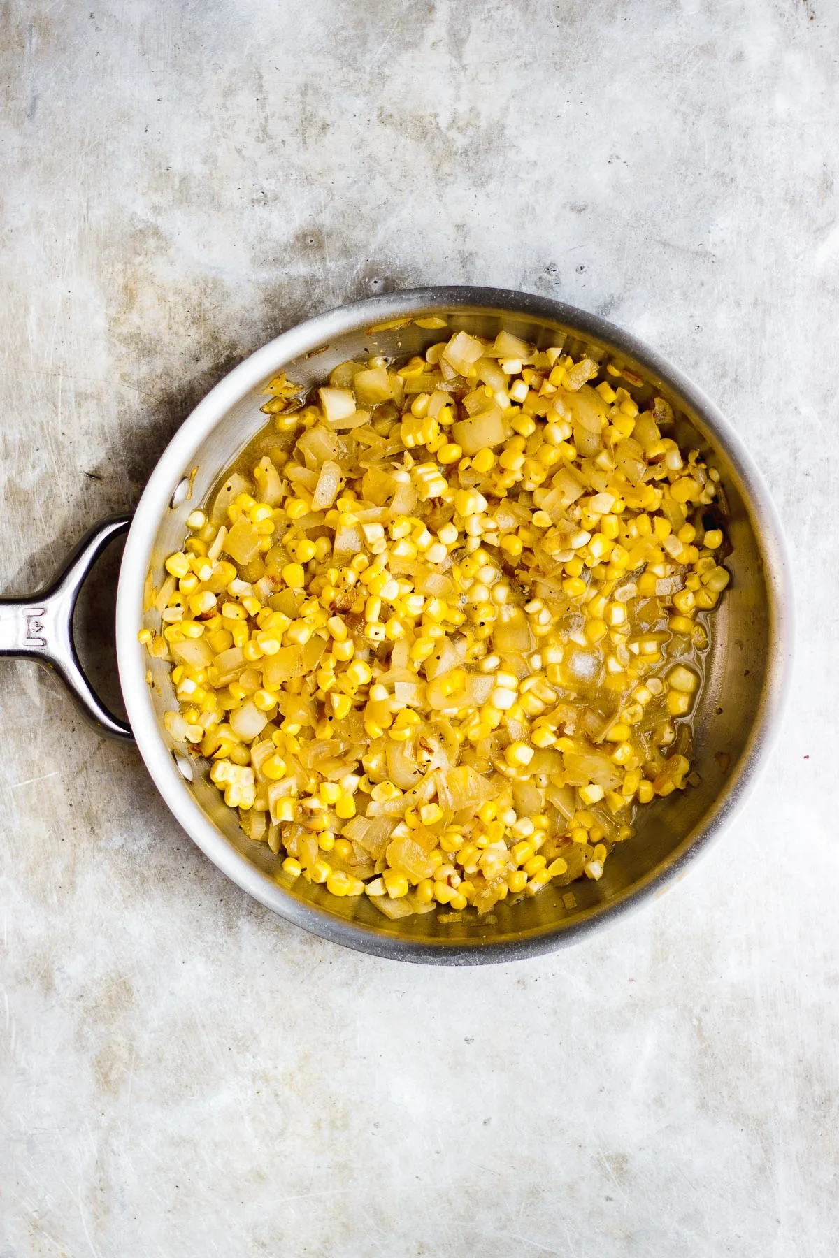 corn and onion in a skillet