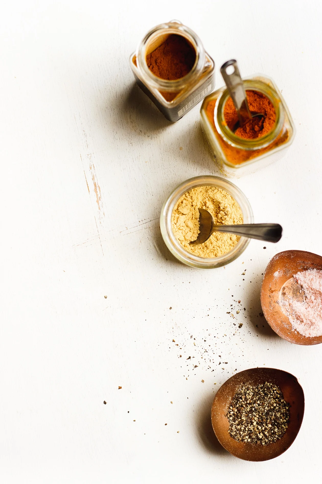 spices in jars on white background