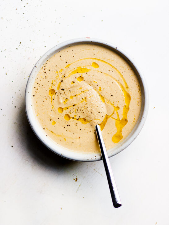 bowl of creamy onion and fennel soup with spoon