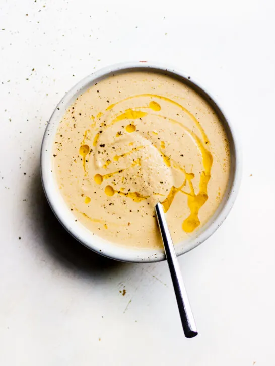 bowl of creamy onion and fennel soup with spoon
