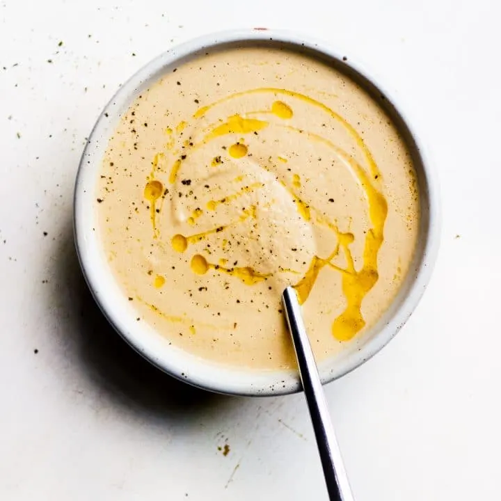 bowl of creamy onion and fennel soup with spoon