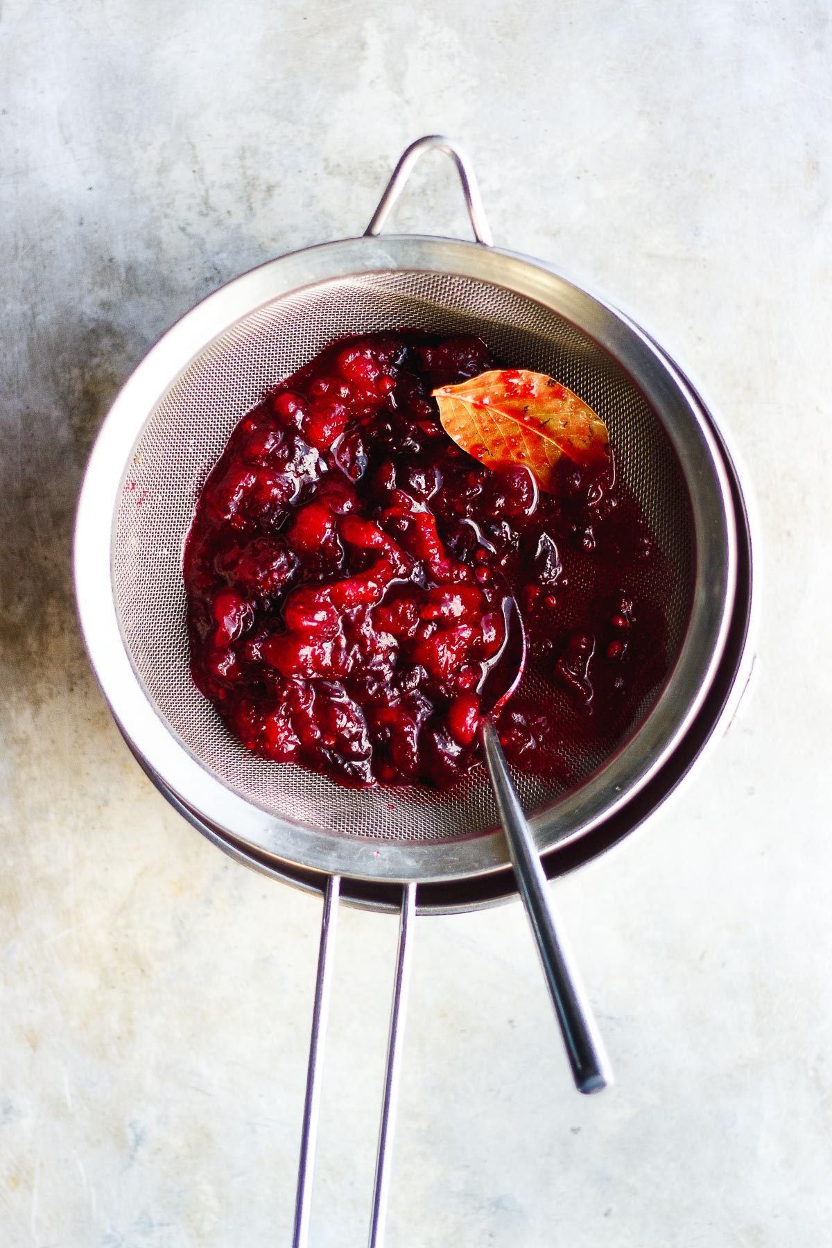 cranberry sauce in a fine sieve