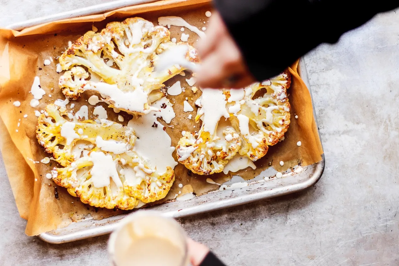 Herbed Cauliflower Steaks with Everyday Lemon Tahini Dressing | Herbed cauliflower steaks with lemon tahini dressing. A simple weeknight meal that is naturally gluten-free, vegan, low-carb and keto-friendly.