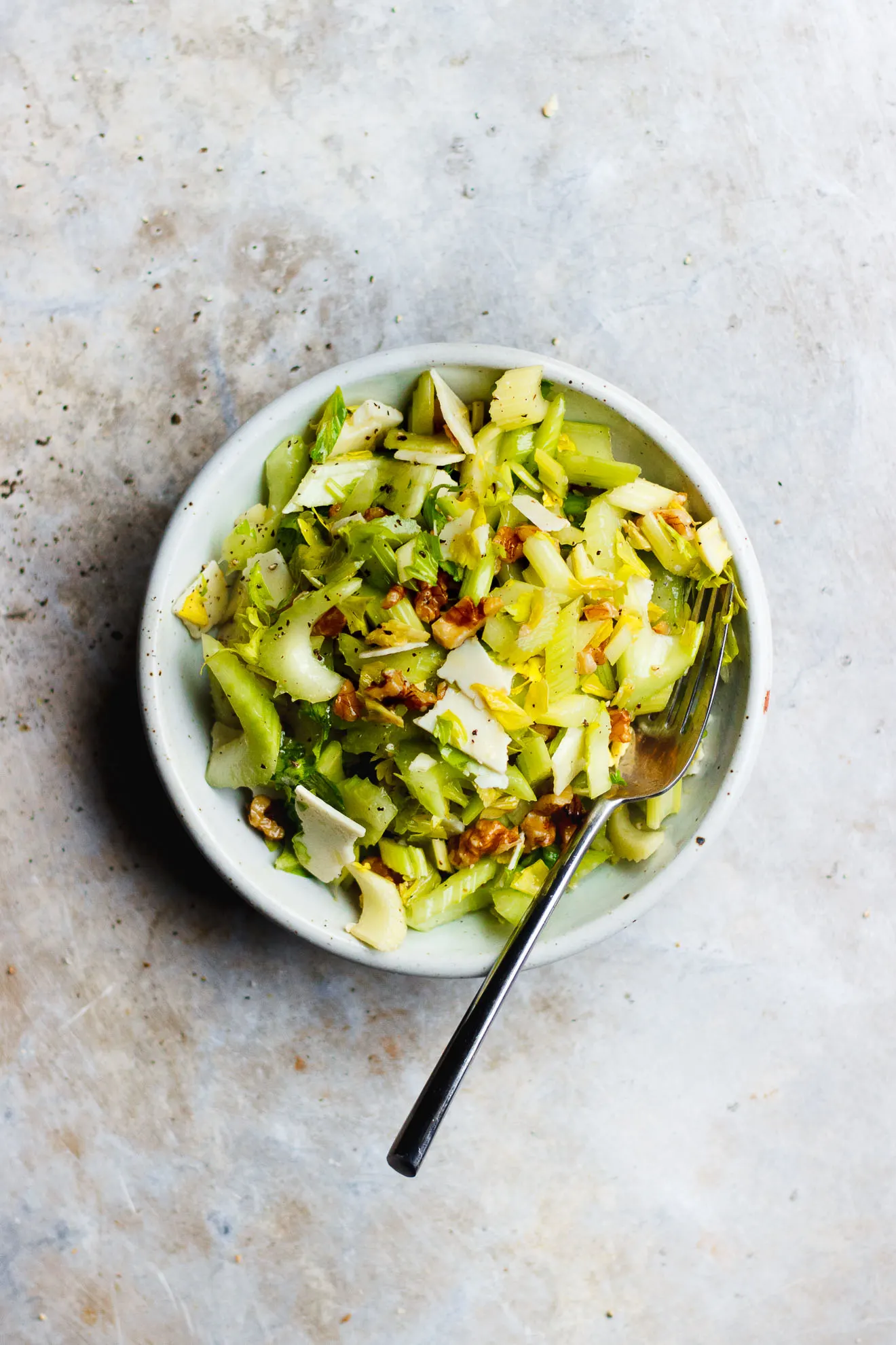 Celery Salad with Parmigiano-Reggiano + Walnuts | A salty, crunchy celery salad with parmigiano-reggiano and walnuts. A classic, three-ingredient celery and parmesan cheese salad.