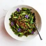 asparagus lentils and edible flower salad in a bowl