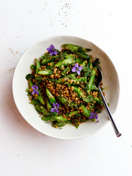 asparagus lentils and edible flower salad in a bowl