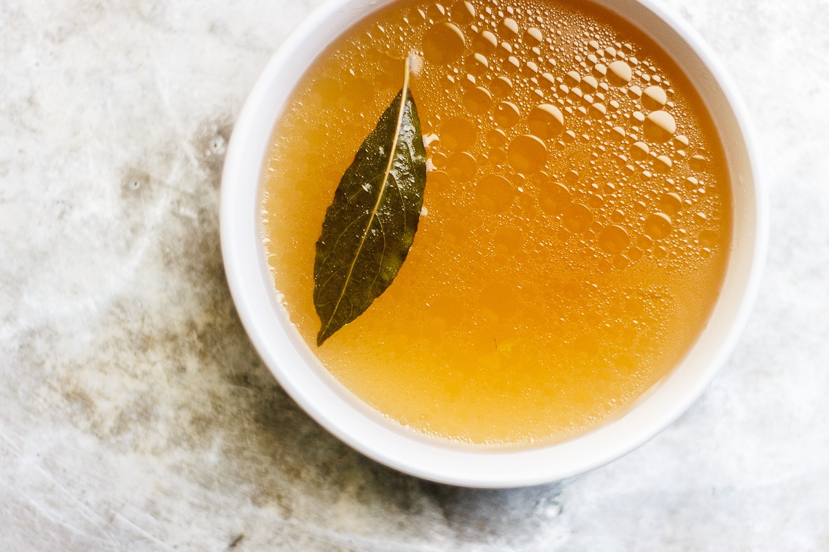 A healing, soothing, restorative vegetable broth flavored with bay leaf and peppercorn. A vegan, nutrient-dense sipping broth or for using in recipes. #veganbroth #vegetablebroth #bayleafrecipes #restorativebroth #sippingbroth