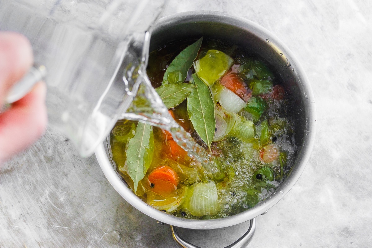 A healing, soothing, restorative vegetable broth flavored with bay leaf and peppercorn. A vegan, nutrient-dense sipping broth or for using in recipes. #veganbroth #vegetablebroth #bayleafrecipes #restorativebroth #sippingbroth