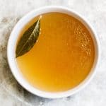 A healing and soothing, restorative vegetable broth flavored by bay leaf and peppercorn. A vegan, nutrient-dense broth for sipping or use in recipes. #veganbroth #vegetablebroth #bayleafrecipes #restorativebroth #sippingbroth