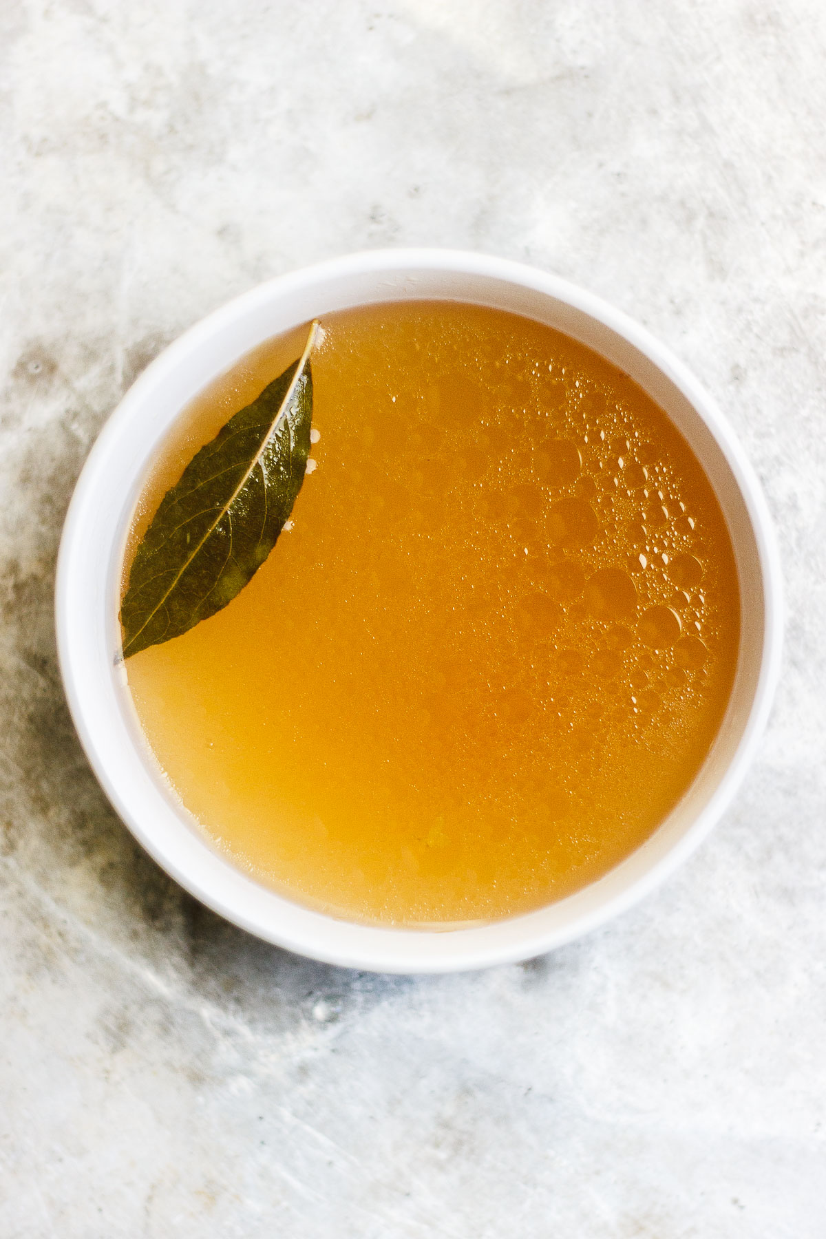 A healing, soothing, restorative vegetable broth flavored with bay leaf and peppercorn. A vegan, nutrient-dense sipping broth or for using in recipes. #veganbroth #vegetablebroth #bayleafrecipes #restorativebroth #sippingbroth