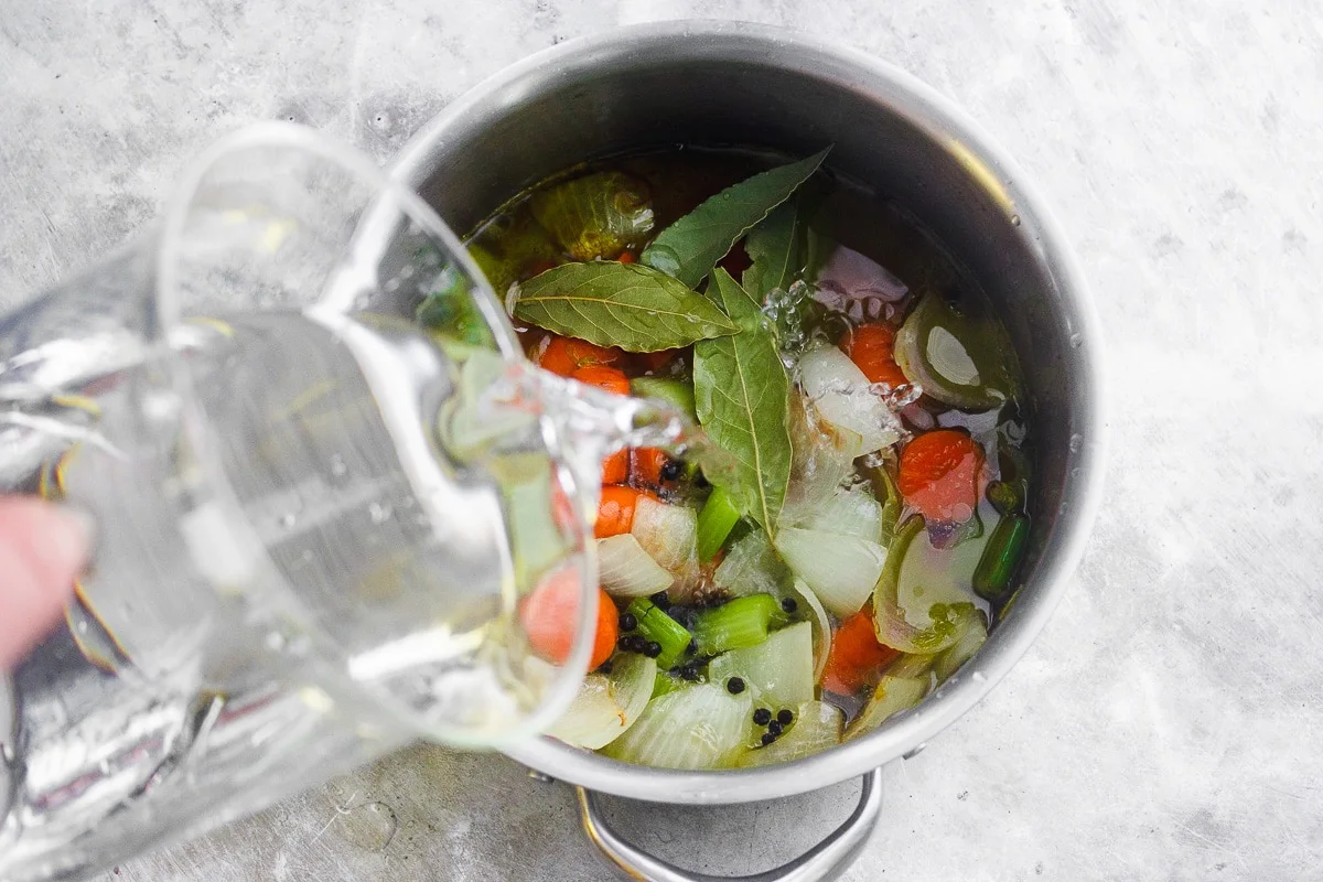 A healing, soothing, restorative vegetable broth flavored with bay leaf and peppercorn. A vegan, nutrient-dense sipping broth or for using in recipes. #veganbroth #vegetablebroth #bayleafrecipes #restorativebroth #sippingbroth