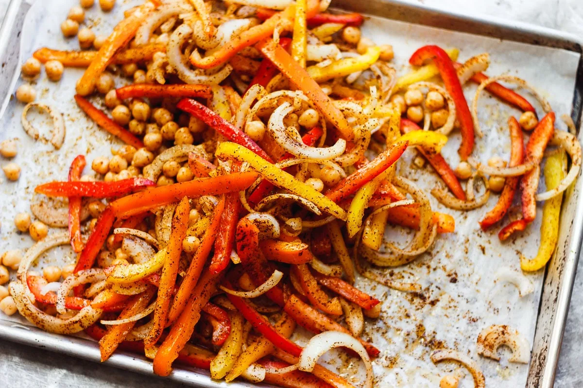 bell peppers and onions and chickpeas on a tray