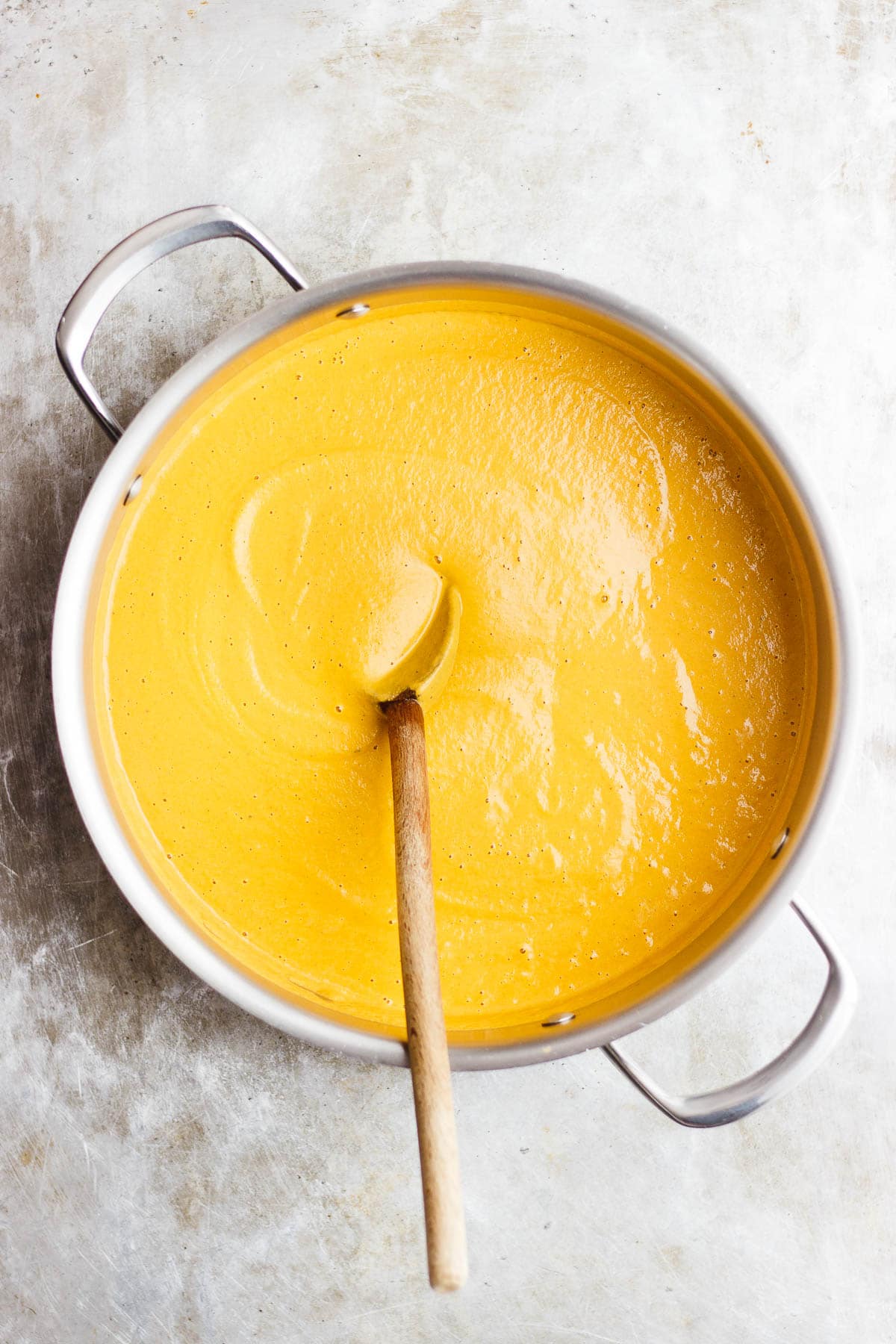creamy carrot soup in a stainless steel pot
