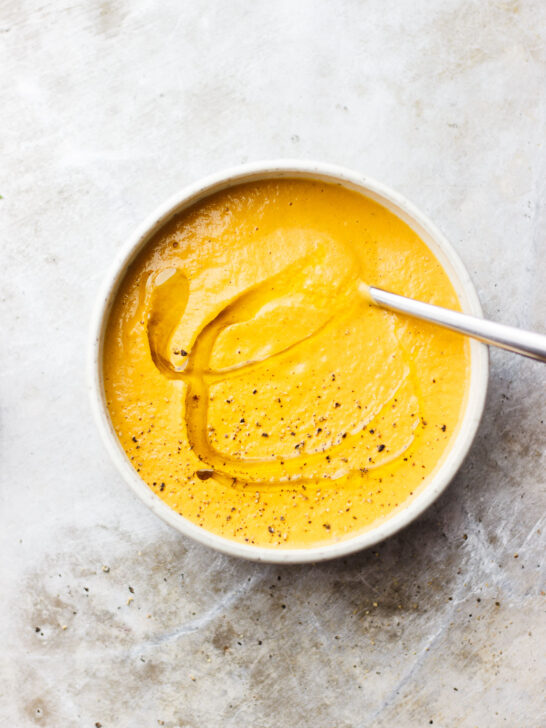 creamy carrot soup in bowl with spoon