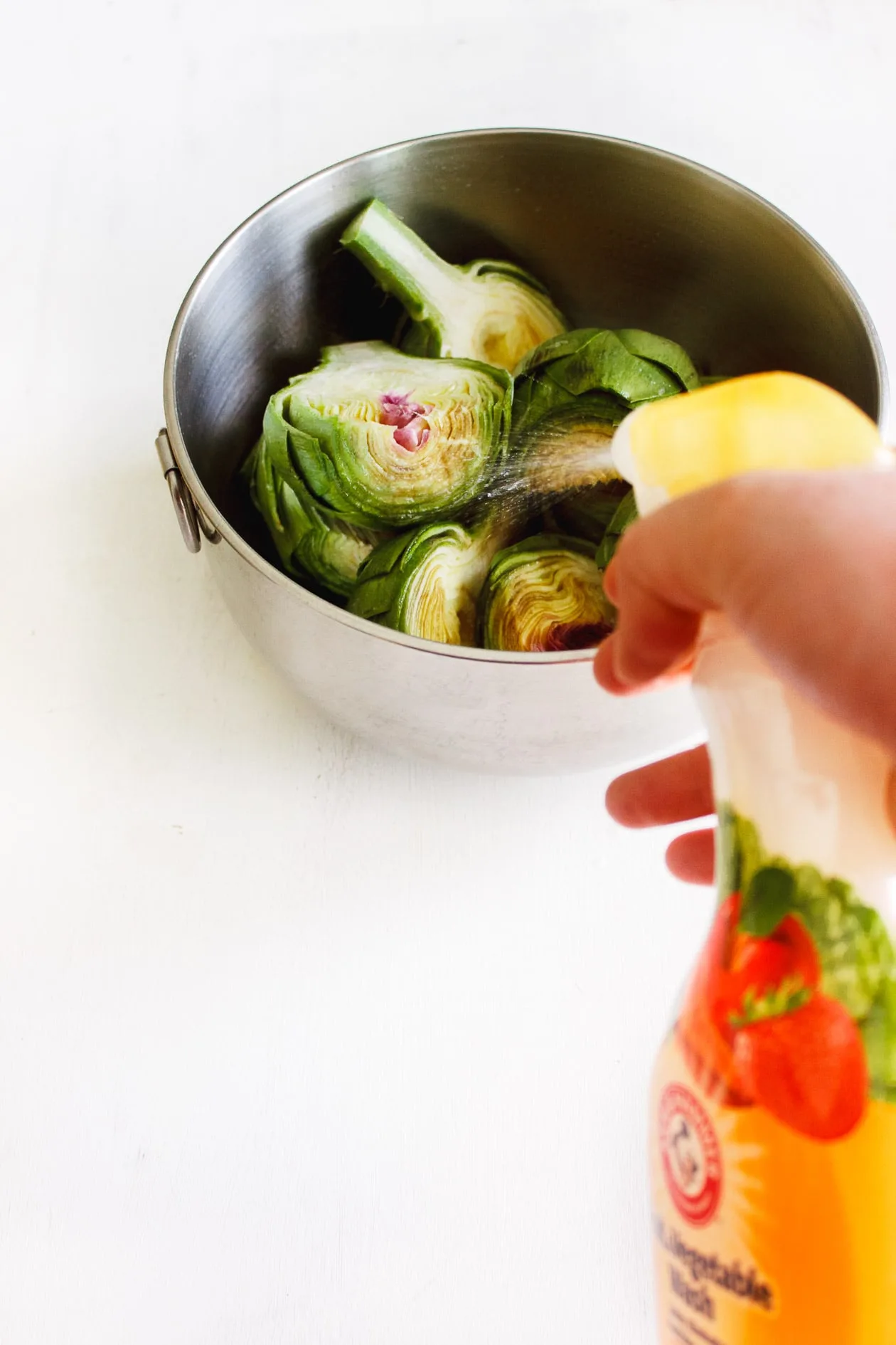 artichokes getting sprayed with vegetable wash