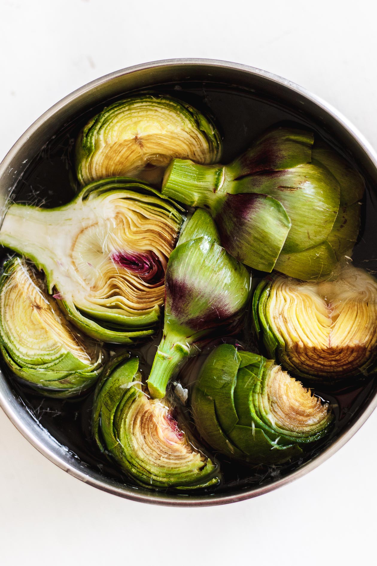 artichokes in a bowl of water