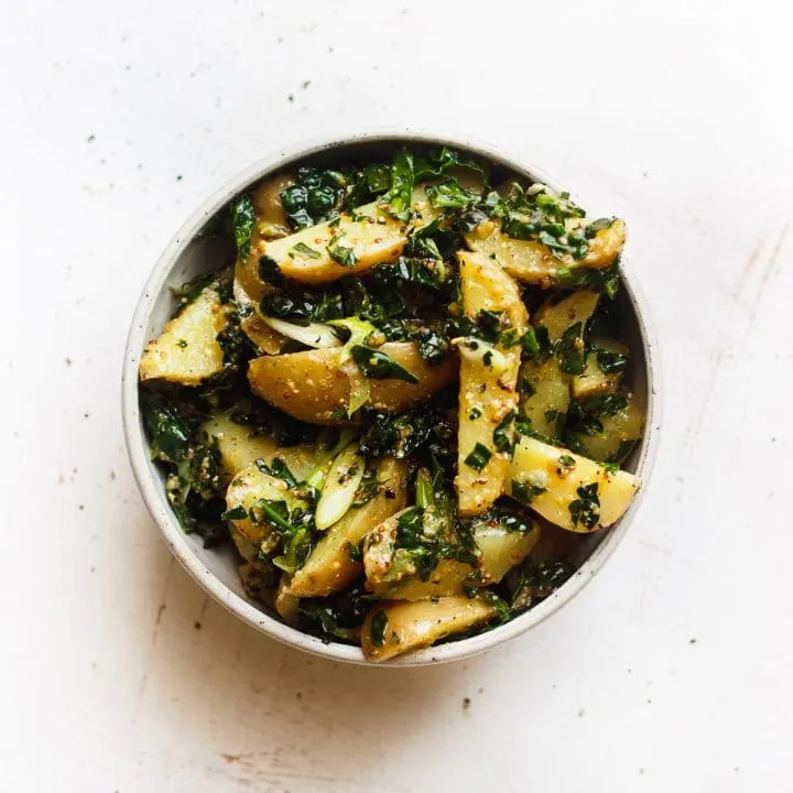 kale potato salad with grainy mustard dressing in a bowl