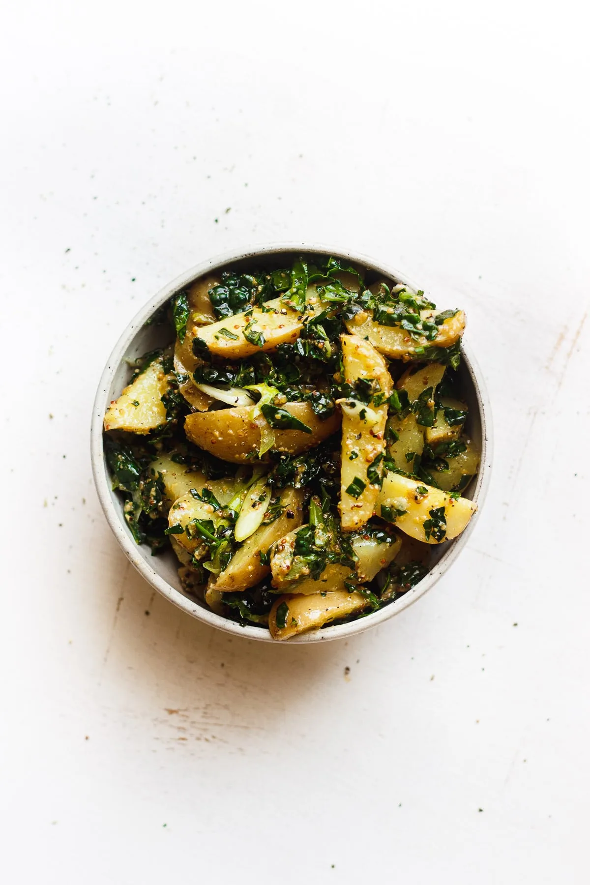 kale potato salad with grainy mustard dressing in a bowl