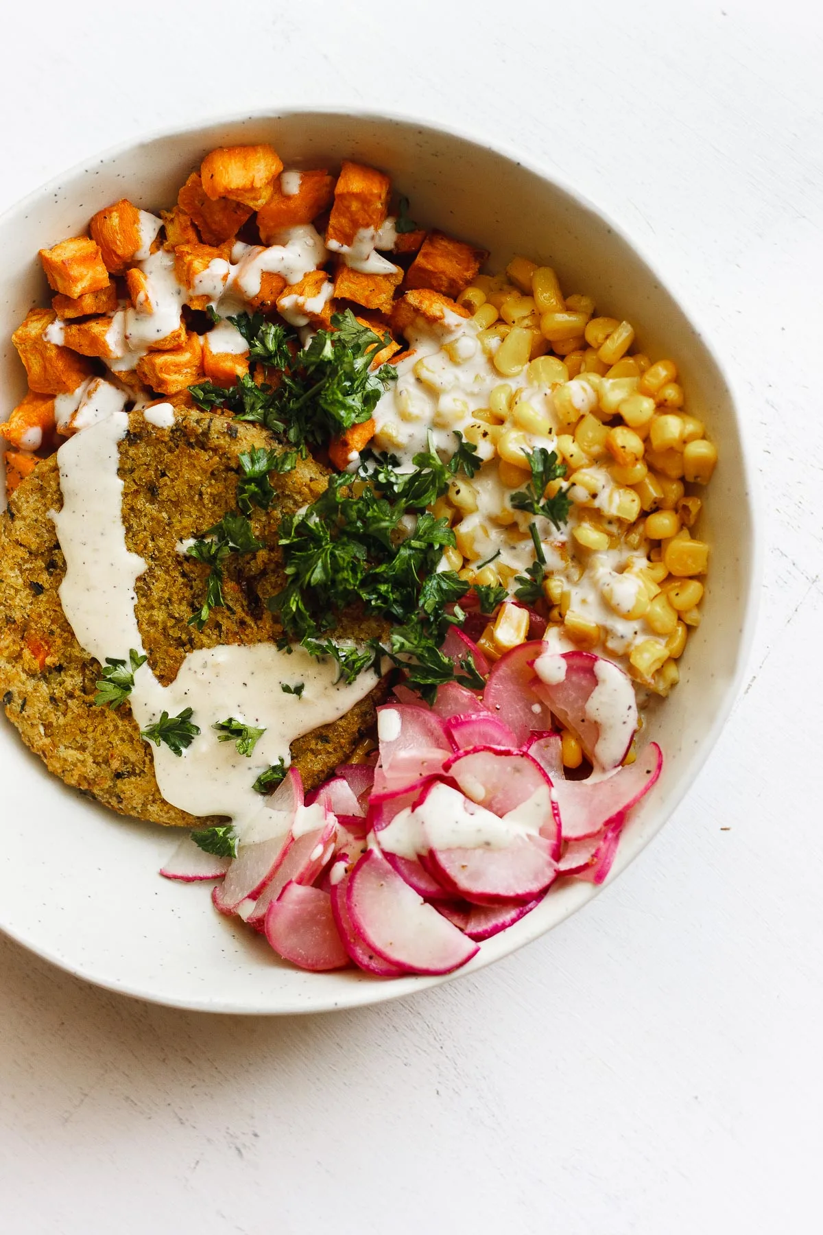 veggie burger bowl with corn and tahini