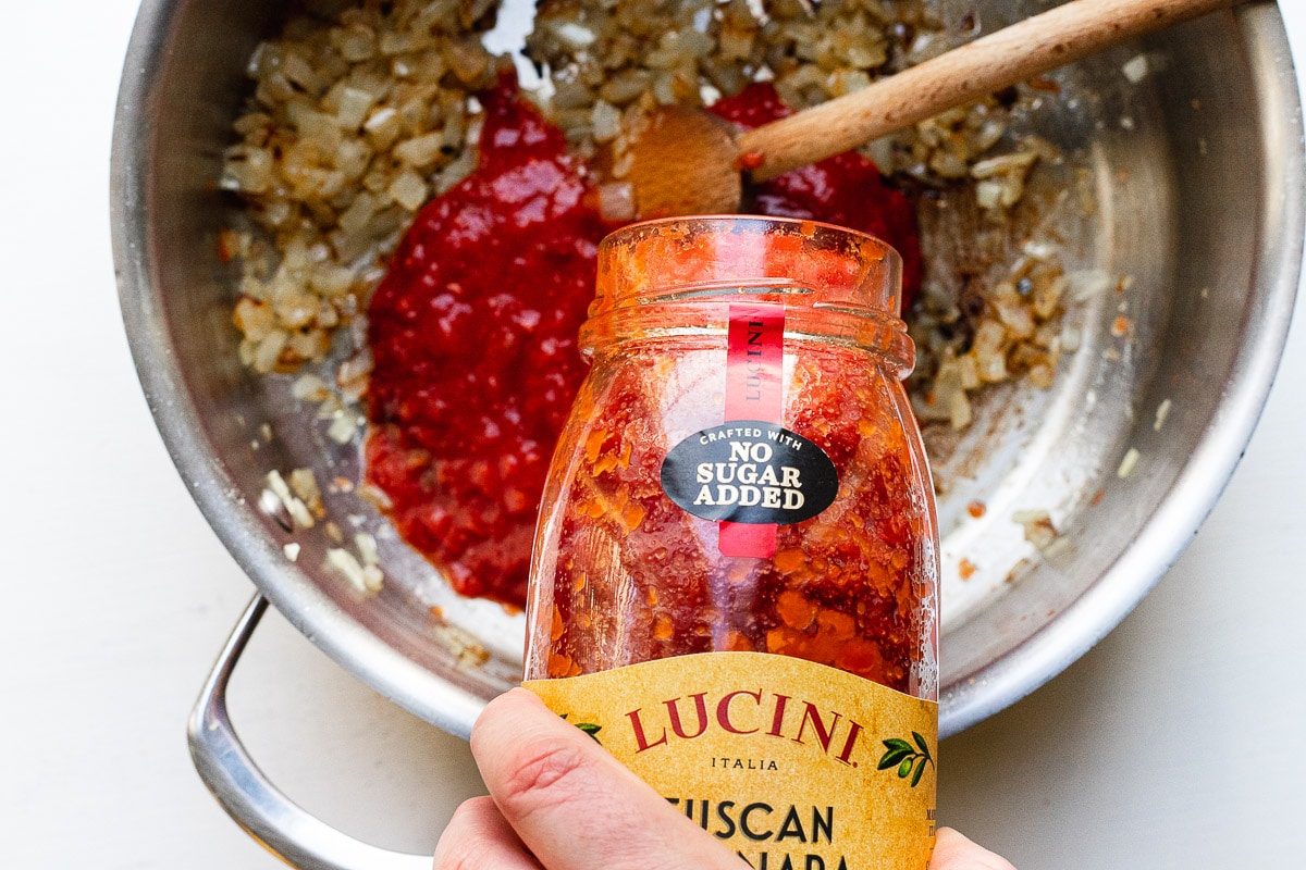 pour shot of lucini tomato sauce